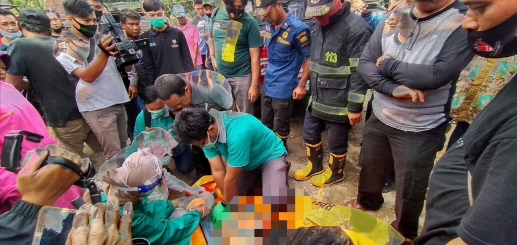 Petugas medis mengecek korban yang meninggal di dalam sumur usai dievakuasi petugas BPBD Sumedang dan lainnya, Sabtu (21/11). (foto: fajarnusantara.com)