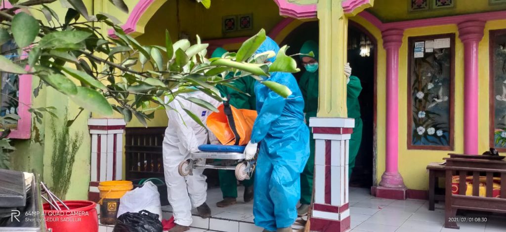 KERANDA : Relawan dari Karang Taruna Desa Mangunarga dan Banser NU Cimanggung membantu petugas kesehatan memakamkan jenazah Covid-19